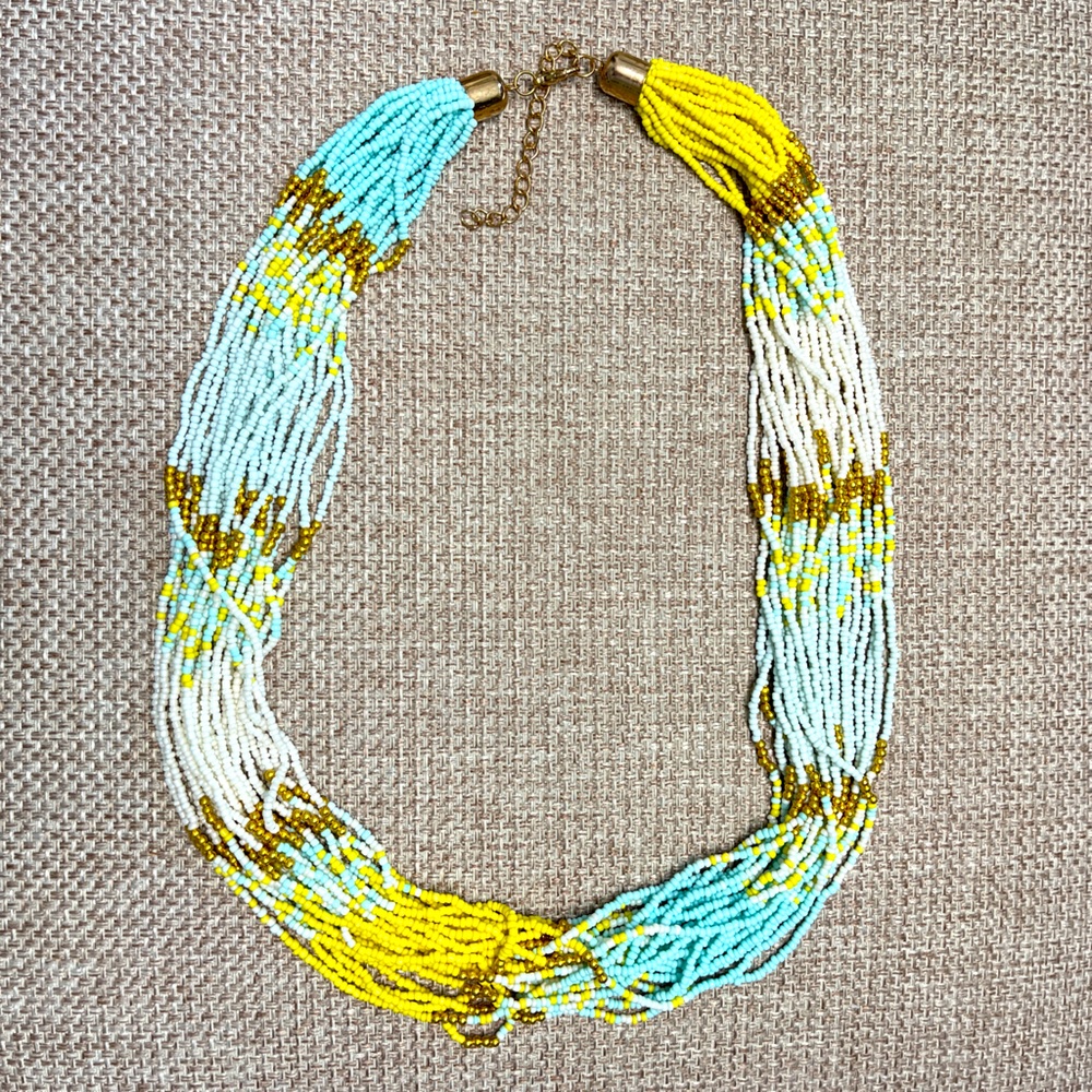 Seed bead necklace, 28”-31” multi strand yellow, light blue, & gold . NIP.